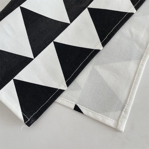 Close-up of geometric triangle pattern and textile texture on minimalist table mat