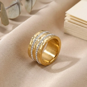 Detailed macro view of gold hammered texture ring with triple row sparkling white zircons