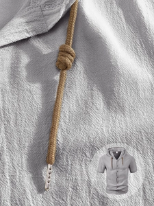 Macro shot of breathable linen fabric texture and braided drawstring with metal tips