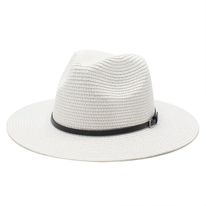 Detail of white straw fedora hat featuring a fine weave and black leather band with buckle