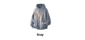 Detailed cable-knit texture of a grey oversized hoodie with drawstring hood and pouch pocket