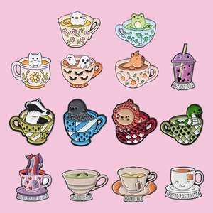 Macro view of fifteen creative animal enamel pins featuring cute cup-themed designs