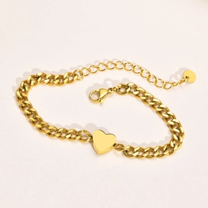 Close-up of gold-plated heart pendant bracelet with a polished curb chain and lobster clasp