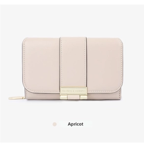 Close-up of apricot litchi grain wallet with gold Classic & Modern metal buckle