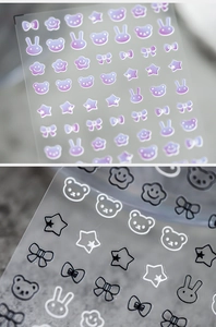 Detail of 3D bunny and bear nail stickers with matte finish and rainbow gradients