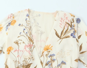 Detail of V-neckline and delicate floral print on lightweight chiffon summer dress