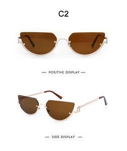 Detail view of gold half-rim cat eye sunglasses with brown lenses and C2 frame design