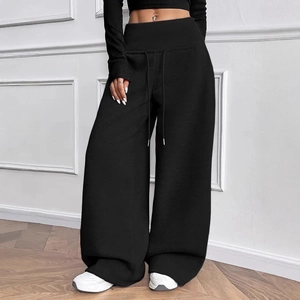Detail of high waisted wide leg joggers with drawstring waist and loose fit style
