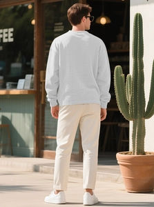 Rear view of man wearing white cable-knit sweater with long sleeves in outdoor cafe