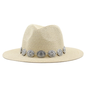Close-up of beige straw Fedora with sun-patterned vintage silver alloy trim band