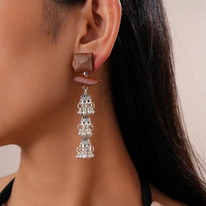 Bohemian hollow square wood earrings with three-layer silver jhumka bells on model