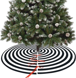 Detail of black and white striped Christmas tree skirt with red ties and pine needles