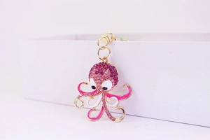 Macro view of octopus keychain pendant with pink rhinestones and gold alloy base