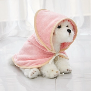 Detailed view of pink microfiber pet bathrobe with hood and yellow trim on a white dog