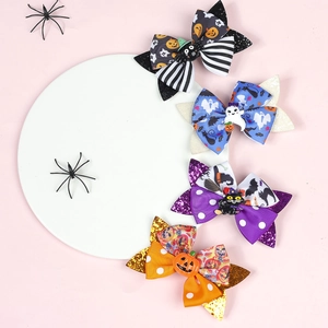 Flat lay of Halloween hair bows with glitter sequins and cute pumpkin ghost charms