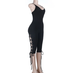Detail of black slim-fit bodysuit featuring side criss-cross lace-up design and knit fabric