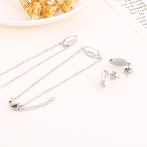 Détail d'un bracelet en argent avec pierres ovales claires et boucles d'oreilles