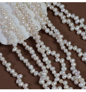 Macro shot of 4-5mm irregular natural freshwater pearls on shell and velvet background