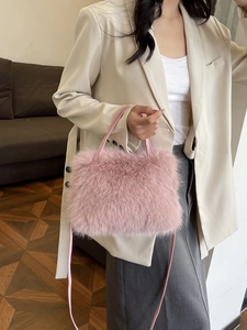 Pink faux fox fur crossbody bag for women with soft fluffy texture and shoulder strap