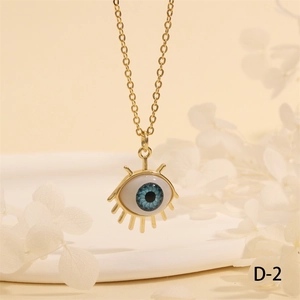 Close-up of a gold Evil Eye pendant necklace with blue eye detail and gold eyelashes