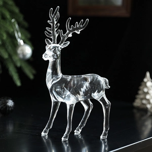 Elegant clear acrylic reindeer Christmas ornament with intricate antlers on snow