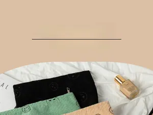 Detailed corduroy texture of makeup bags with smile pattern in black, green and beige
