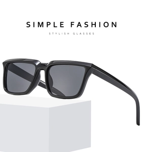Close-up of black square frame sunglasses on a minimalist white geometric display stand