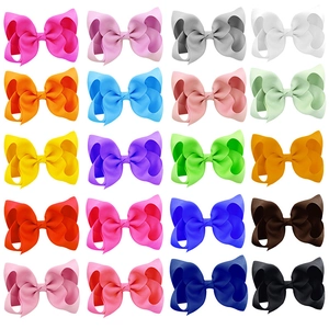 Grid view of twenty colorful 4-inch grosgrain ribbon hair bows for children