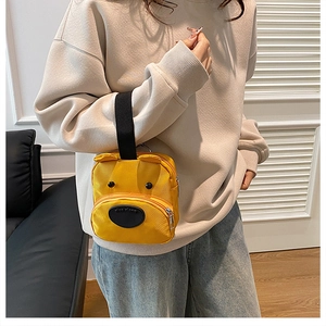 Detail view of yellow cartoon bear canvas handbag with 3D ears and zipper pocket