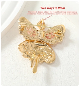 Detail view of the back of a vintage ballet fairy brooch showing pin and pendant hook functions