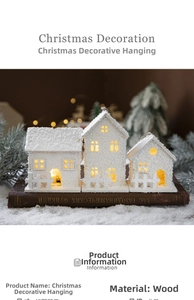 Detailed view of lighted wooden Christmas house ornament with warm LED and artificial snow
