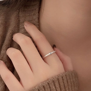 Close-up of minimalist 925 sterling silver twisted ring with a tiny rectangular detail