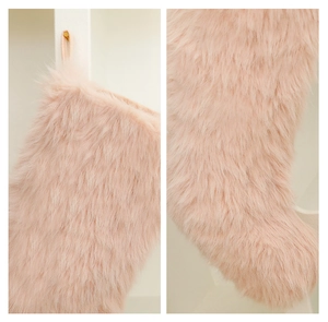 Detail of plush blush pink faux fur Christmas stocking showing soft texture and hanging loop