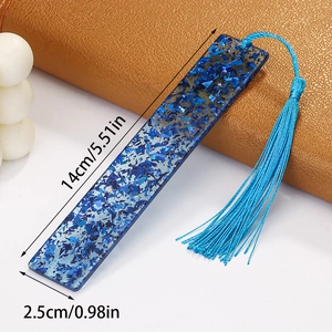 Detailed view of clear acrylic bookmark with blue sequins and fringe measuring 14x2.5 cm