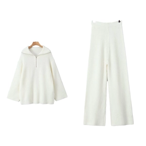 Two-piece white knit lounge set featuring half-zip collar sweater and wide-leg trousers