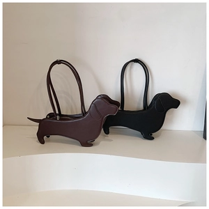 Detail view of creative dachshund shaped shoulder bags in dark brown and black leather