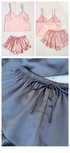 Detailed texture of silk satin sleepwear set featuring ruffled hem and drawstring waist
