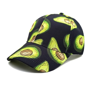 Close-up of vibrant green avocado print patterns on a black cotton baseball cap