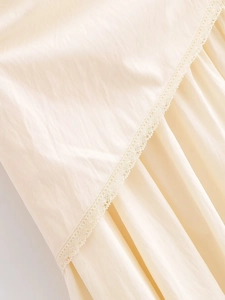Detailed view of cream ruffled skirt featuring delicate lace trim and pleated fabric texture