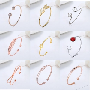 Set of nine assorted adjustable open cuff bracelets in rose gold, gold, and silver finishes