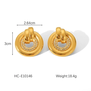 Macro shot of gold hoop earrings with sparkling diamonds and size measurements