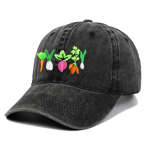 Macro detail of high-quality vegetable embroidery on a black washed denim baseball cap