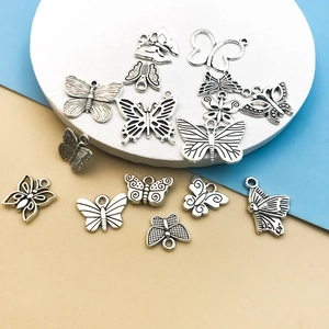 Flat lay of Tibetan silver butterfly alloy charms for DIY jewelry making and crafts