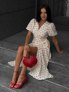 Detail of white cotton wrap dress with red heart print and side waist tie detail