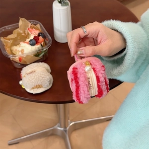 Close-up of plush macaron earphone case with pearl zipper and soft texture