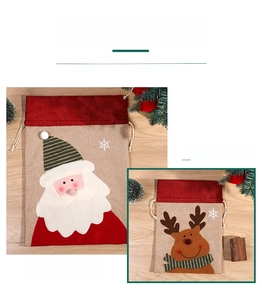 Detail of Christmas drawstring gift bags featuring 3D Santa and Reindeer fabric designs