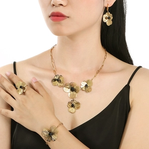 French vintage gold petal jewelry set with necklace earrings and bracelet on model