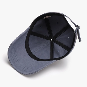 Distressed wash baseball cap in blue-grey with vintage frayed edges and adjustable strap