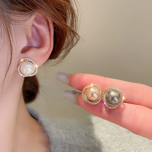 Macro view of vintage pearl stud earrings with sparkling zircon wrap in three colors