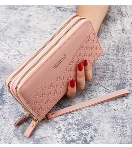 Detailed view of pink double zipper long wallet with embossed pattern and wrist strap